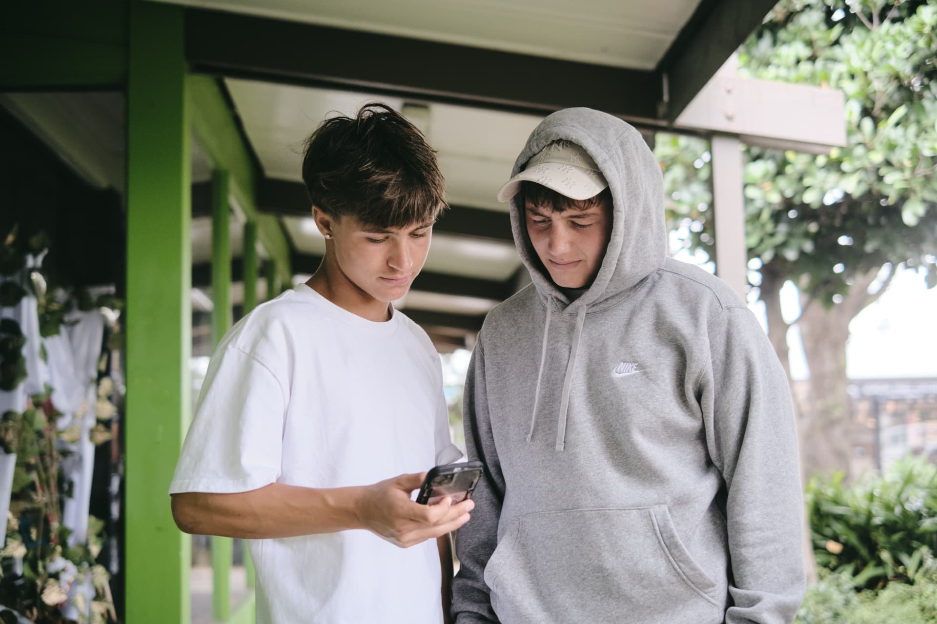 Two young people looking at a phone together