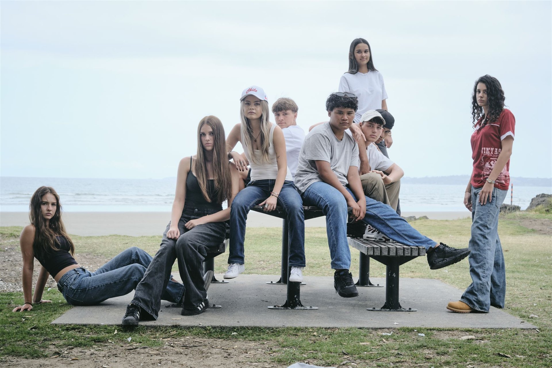 A group of young people by the beach in Aotearoa